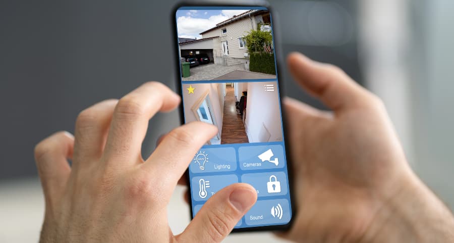 Homeowner checking surveillance camera streams on a cell phone